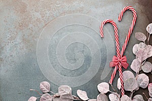 Christmas candy cane lied on blue background. Flat lay and top view