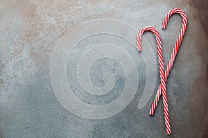 Christmas candy cane lied on blue background. Flat lay and top view
