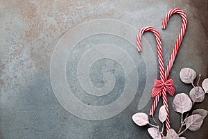 Christmas candy cane lied on blue background. Flat lay and top view