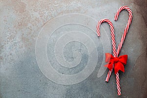 Christmas candy cane lied on blue background. Flat lay and top view