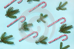 Christmas candy cane lied evenly in row on blue background. Flat lay and top view.