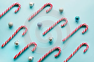 Christmas candy cane lied evenly in row on blue. Flat lay and top view
