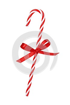 Christmas candy cane with satin red bow isolated on white background