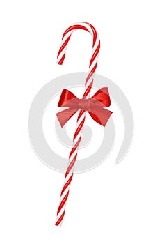 Christmas candy cane with shiny red bow isolated on white background