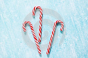 Christmas candy canes on blue background