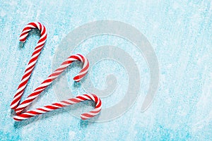 Christmas candy canes on blue background