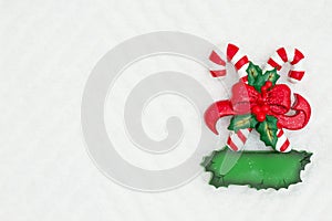 Christmas candy canes with a bow on white chevron textured fabric background