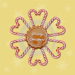 Christmas candy canes in hearts and snowflake shapes with red striped ribbon and cookie with Merry Christmas text