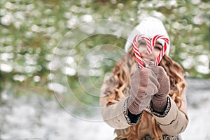 Christmas Candy Heart. New Year's adult girl made Christmas tree caramels in the shape of a heart.