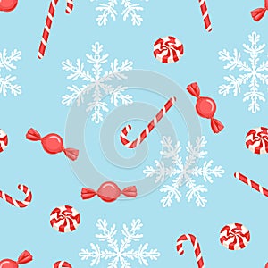 Christmas candy pattern. White snowflakes, red candies and lollipops on blue background.