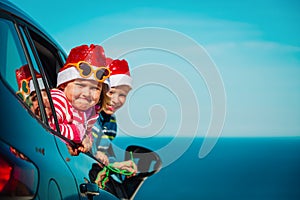 Christmas car travel- happy kids travel in winter at sea