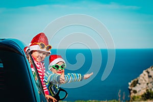 Christmas car travel- happy kids travel in winter at sea