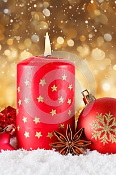Christmas card advent time with burning candle decoration golden background with copyspace copy space portrait format