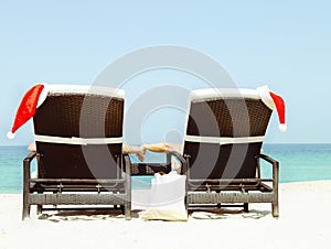 Christmas card or background - couple in sunloungers with Santa photo