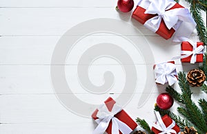 Christmas card. Christmas layout with boxes and fir on a white wooden background
