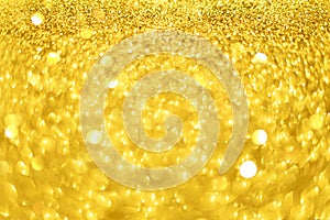 Christmas card with copy space, gold bokeh, sparkles, defocused lights. Festive abstract texture. Glittering background