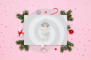 Christmas card with copy space. Princess on blank white paper in frame of natural fir tree branches, gifts and