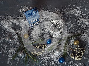 Christmas card with decorative Christmas toys with strong snow on the Black wooden background