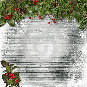 Christmas card. Fir branches and holly on a wooden background