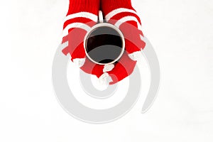 Christmas card, gloves on hands holding cup of cofee isolated on
