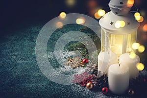 Christmas card with glowing candle and lantern on blue background