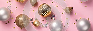 Christmas card with golden and silver balls on pink background banner