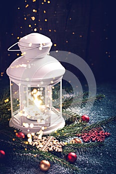 Christmas card with holiday mood. Festive burning lantern. Natural decor, front view