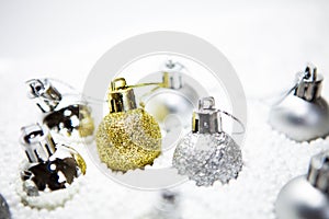 Christmas card, illustration with golden baubles, balls, decorations, ornaments on a silver white background with blurry, blurred