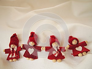 Christmas card, little red elfs with white heart on dress and knitted hat on white background, winter background