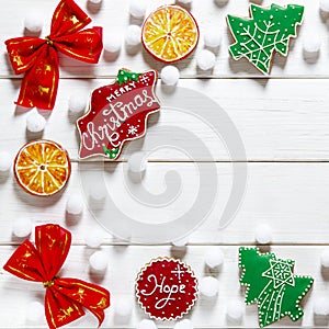 Christmas card: multi-colored Christmas toys and ginger cookies in the form of green Christmas trees lie on a colorful background