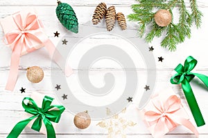 Christmas card with pink and emerald green elements, golden ornaments, confetti and wrapped gifts. Christmas flat lay