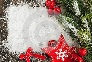 Christmas card with snow, red star and fir-tree branch