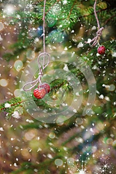Christmas card with strawberries on a spruce branch. Snow.