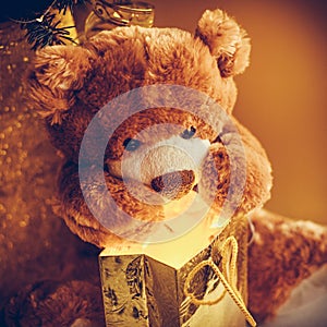 Christmas card with Teddy Bear opening gift and holiday decoration