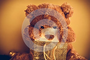 Christmas card with Teddy Bear opening gift and holiday decoration