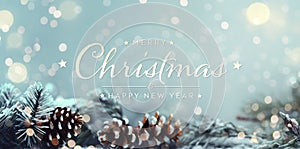 Christmas card with tree branches and pine cones. Merry Xmas background with lights on blue snowy surface. Happy New Year.