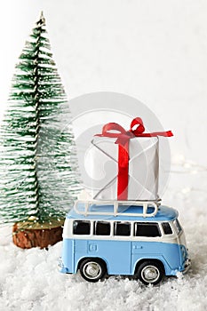 Christmas Card with vintage car and xmas gift in wintery landscape