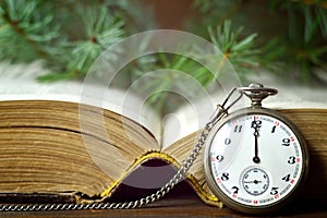 Christmas card with vintage pocket watch and old book