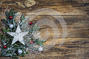 Christmas card with white star and christmas baubles on fir branch