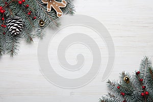 Christmas card. White wooden background with snow fir tree and decoration. Top view with copy space for your text