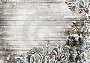 Christmas card on a wooden board with beautiful snowy leaves