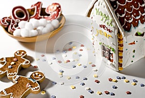 Christmas card: on a wooden plate are red ginger cookies in the shape of numbers 2019 and white round snowflakes
