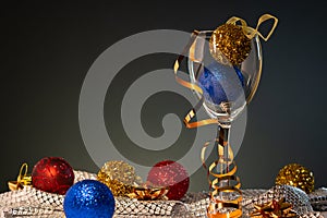 Christmas cards. Wine glass with red, blue and gold Christmas decorations photo