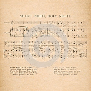 Christmas carol. Old music sheet Silent Night. Used paper background