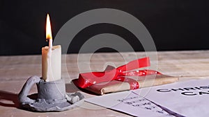 Christmas carol song sheet with candle and gift