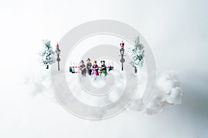 Christmas carolers floating on a cloud of cotton