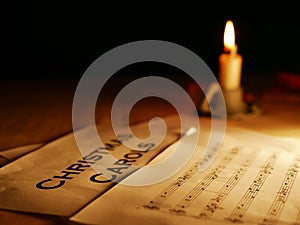 Christmas carols music song sheet with candle