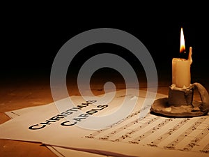 Christmas carols music song sheet with candle