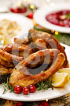 Christmas carp, Fried carp fish slices on a white plate, close up.