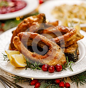 Christmas carp, Fried carp fish slices on a white plate, close up.